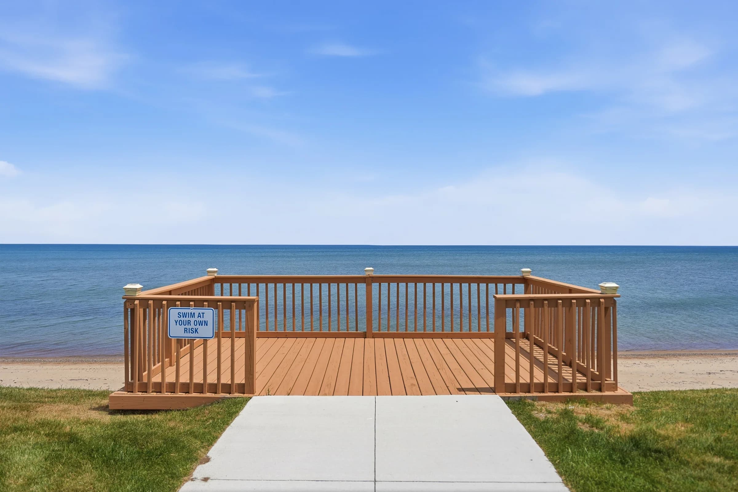 Lakefront viewing deck on the sandy beach at Huron Shores MHC